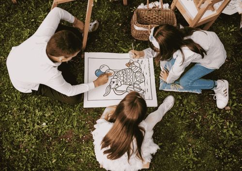 children coloring in grass