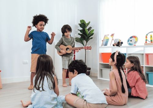 kids singing boy playing guitar
