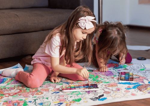 two girls coloring
